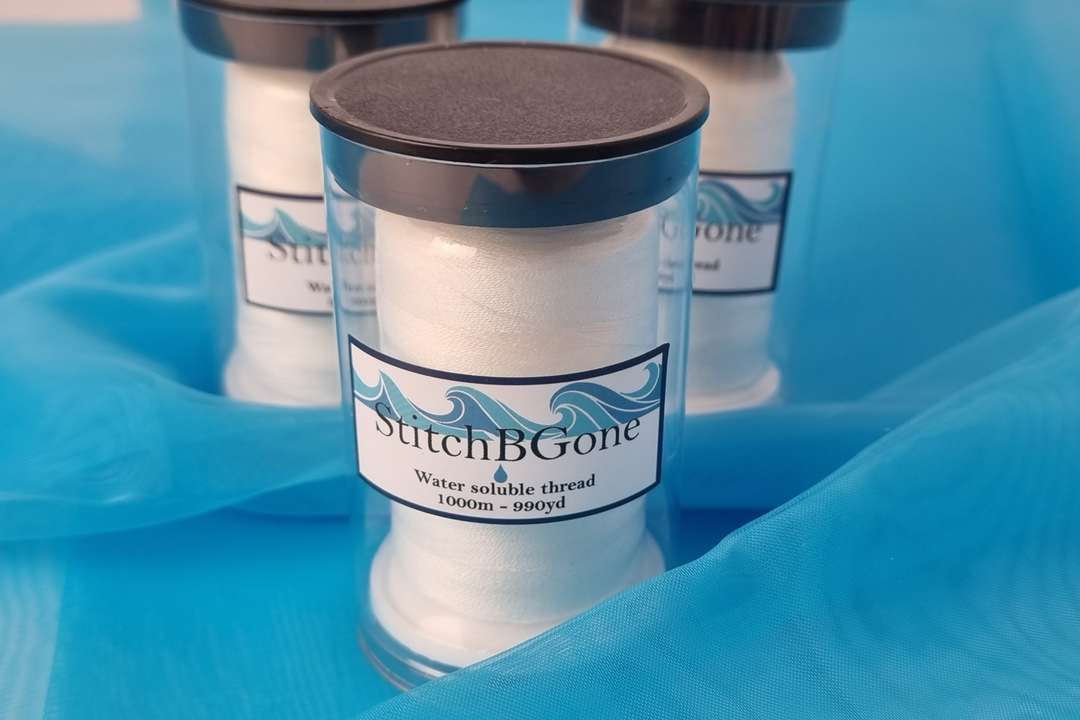 StitchBGone water soluble thread container on a blue background